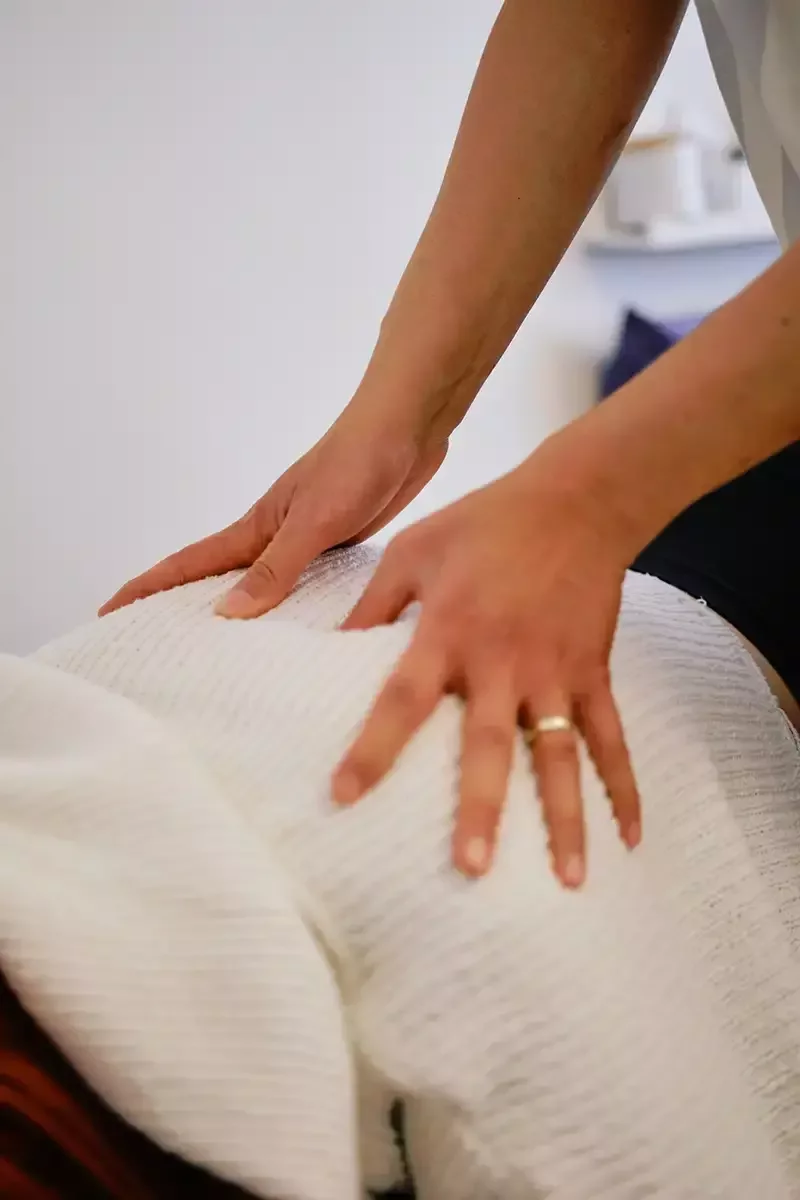 Dr. Leo Quan performing a chiropractic examination on a patient at Source Chiropractic in Toronto.
