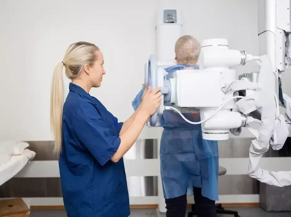 Professional In Uniform Taking X-ray Of Patient