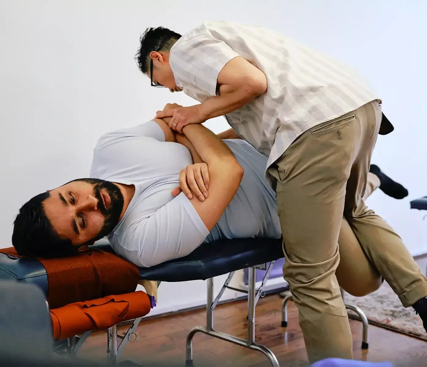 Dr. Leo Quan performing a manual low back chiropractic adjustment on a patient at Source Chiropractic in Toronto.