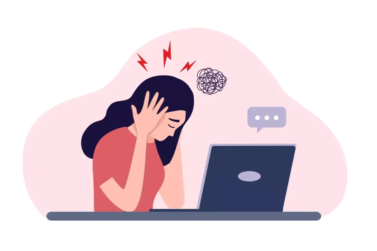 Office worker experiencing a headache while working on a laptop