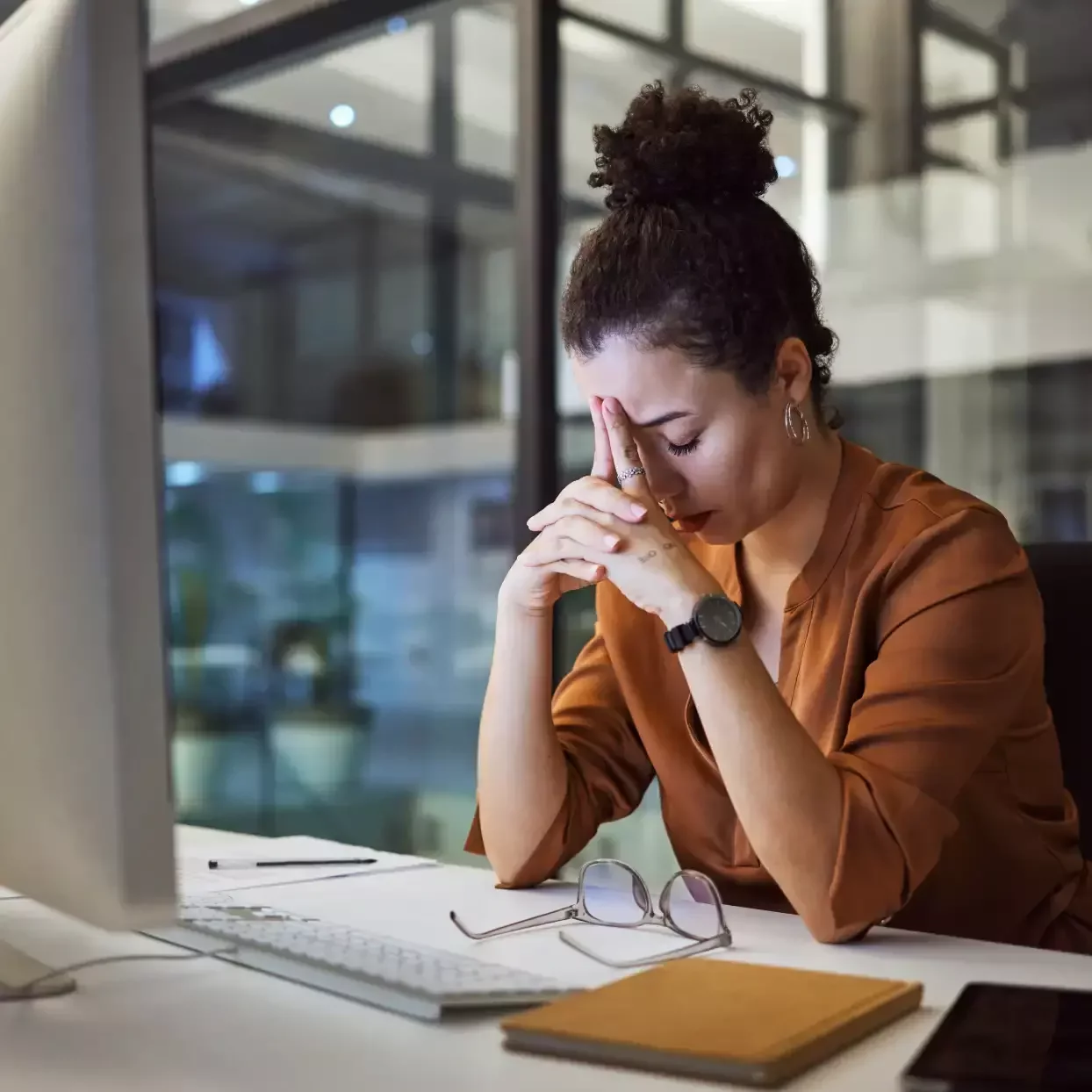 Office worker experiencing headache and fatigue after prolonged desk and computer work.