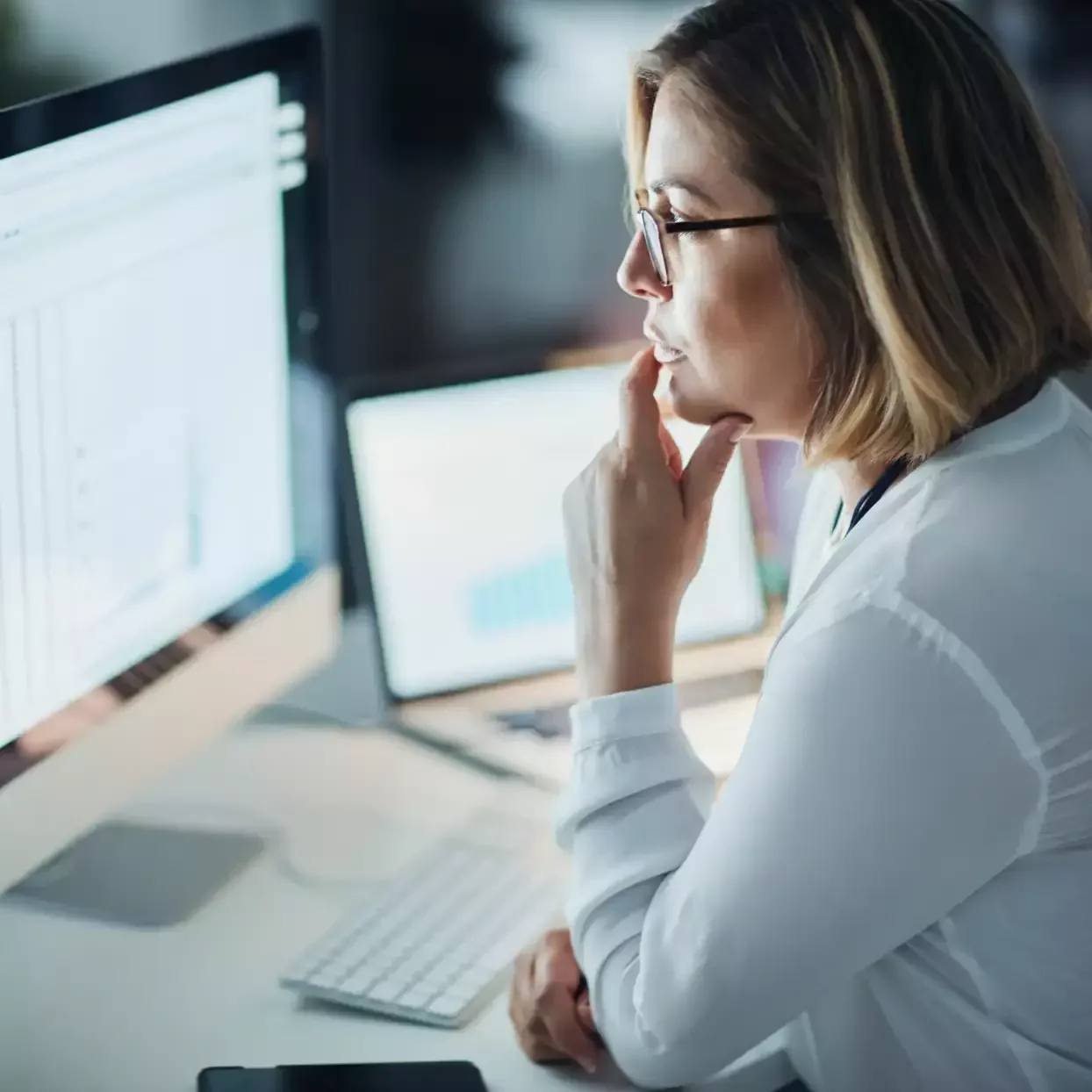 Office worker concentrating on a computer screen during prolonged desk work.
